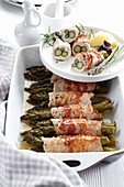 Asparagus rolls baked in chicken fillet and bacon