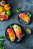 Bread topped with cream cheese and citrus fruit slices