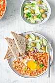 Beans in tomato sauce with egg and cucumber salad