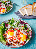 Fried egg salad with sundried tomatoes, parmesan cheese and sambal sauce