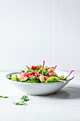 Wild herb salad with pomegranate seeds and figs