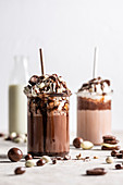 Chocolate shakes with whipped cream and chocolate and yogurt covered nuts and raisins