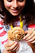 Young woman with cinnamon pecan sticky bun