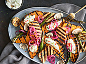 Grilled sweet potatoes with cream cheese and pickled onions