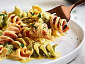 Colorful fusilli with vegan 'cheese sauce'