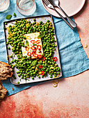Baked feta with peas, chilli and preserved lemon