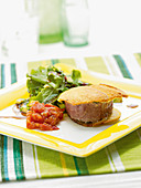 Tuna steak with peppery tomato relish and a side salad