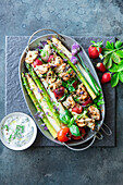 Asparagus with chicken and strawberry skewers