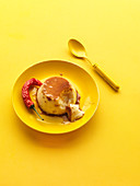 Crème caramel (flan) with chili on a yellow background