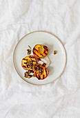 Grilled peaches with caramelized nuts