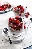 Chia dessert with raspberries and cherries sprinkled with chocolate