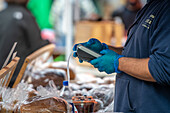 Man using electronic pay system at farmers market