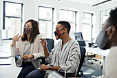 Business people in face masks meeting in office