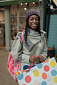 Confident young woman with shopping bag