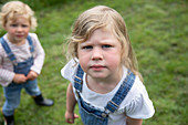 Girl in overalls with sister