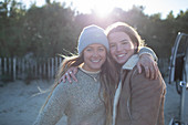 Happy young women friends hugging outdoors