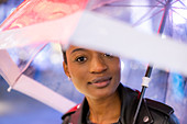 Young woman under umbrella