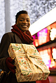 Happy young woman with Christmas below lights
