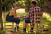 Couple at garden table with fresh harvested vegetables