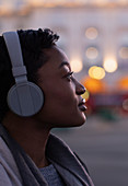 Young woman with headphones looking away