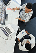 Business people video conferencing at computer in office
