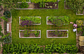 Aerial view couple gardening in garden with raised beds