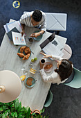 Businesswomen discussing paperwork at breakfast meeting