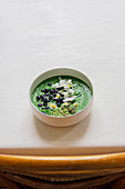 Deep green spirulina bowl with hemp seeds and coconut water