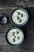 Creamy wild herb soup with spinach dumplings