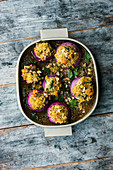 Braised red onions with an oriental nut and bulgur filling