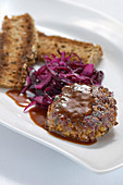 Wild boar meatball on red cabbage salad