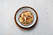 Vegan chocolate millet porridge with cashew milk and apple