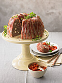 Savoury minced beef and feta Bundt cake wrapped in bacon
