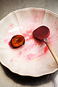 Making plum jam: used wooden spoon on a plate