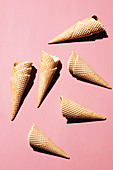 Empty ice cream cones on a pink background