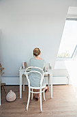 Blonde woman sitting at the desk under the umbrella