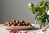Cherry tomatoes in a bowl with basil