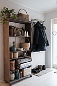 Wooden shelf with rustic decoration in the rustic entrance area
