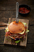 Burger with wild boar patty, halloumi and bacon
