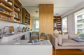 Kitchen with shelves and sleeping area in an open-plan interior