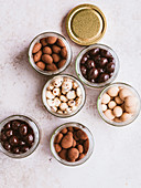 Chocolate coated nuts in jars