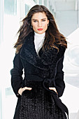 A brunette woman wearing a black winter coat