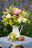 Rural summer bouquet with roses, lady's mantle, feverfew, lavender and carnations