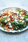 Lukewarm pasta salad with summer vegetables and feta cheese