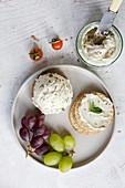 Cream cheese with crackers and grapes