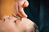 Ayurvedic forehead massage therapy with essential oil