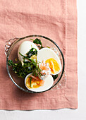 Eggs in a glass with baby spinach and salmon