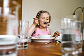 Girl eating at table