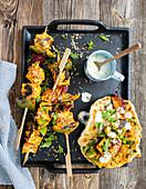 Turmeric paneer skewers with grilled naan and a coconut mint dip