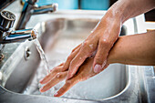 Close-up of woman washing hands, Devon, England, UK